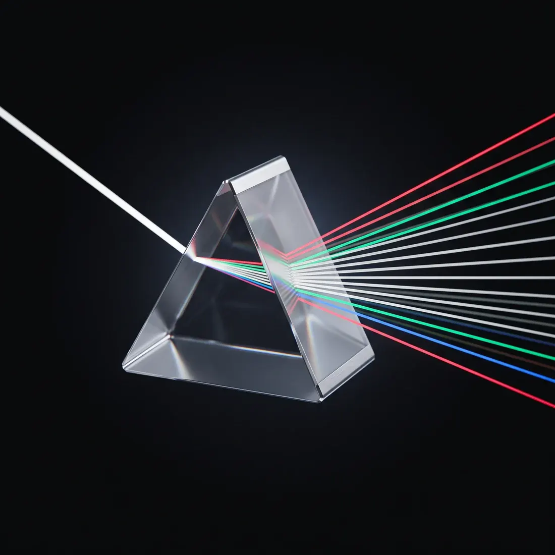 A dispersion prism fanning one white beam into a dozen finely separated rays.